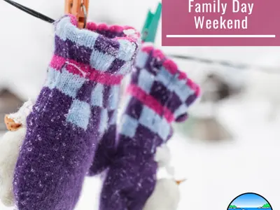 Purple wool mittens hanging on a clothes line outside in the snow.